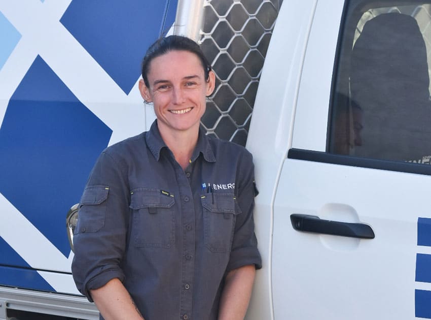Lenergy team leader smiling in front of work van on site about to install solar